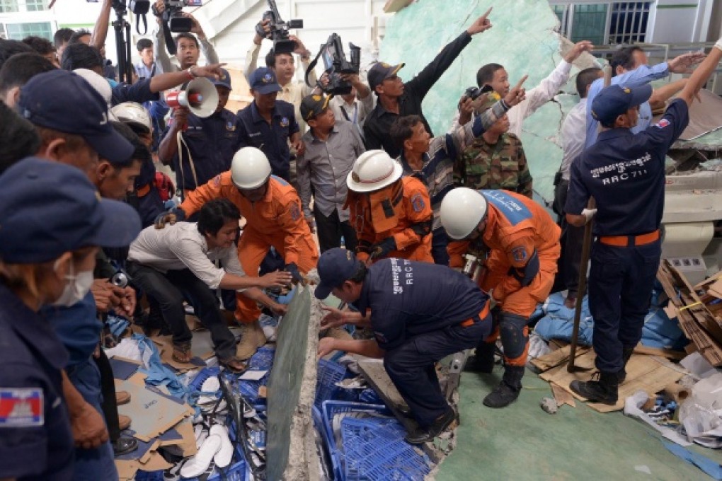 Rescue teams and soldiers look for workers after the ceiling collapse at the shoe factory in Kampong Speu yesterday. Photo: AFP