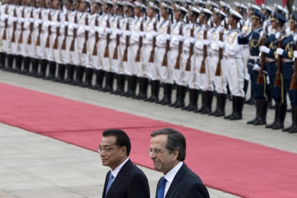 Li Keqiang, left, inspecting a guard of honour with Antonis Samaras in Beijing on Thursday. Photo: AP