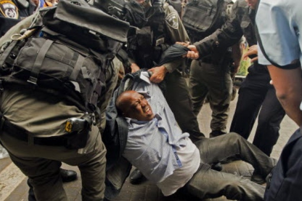Israeli security forces arrest a Palestinian man during a demonstration in Jerusalem. Israel is set to ‘legalise’ wildcat settler outposts, an NGO said on Thursday. Photo: AFP