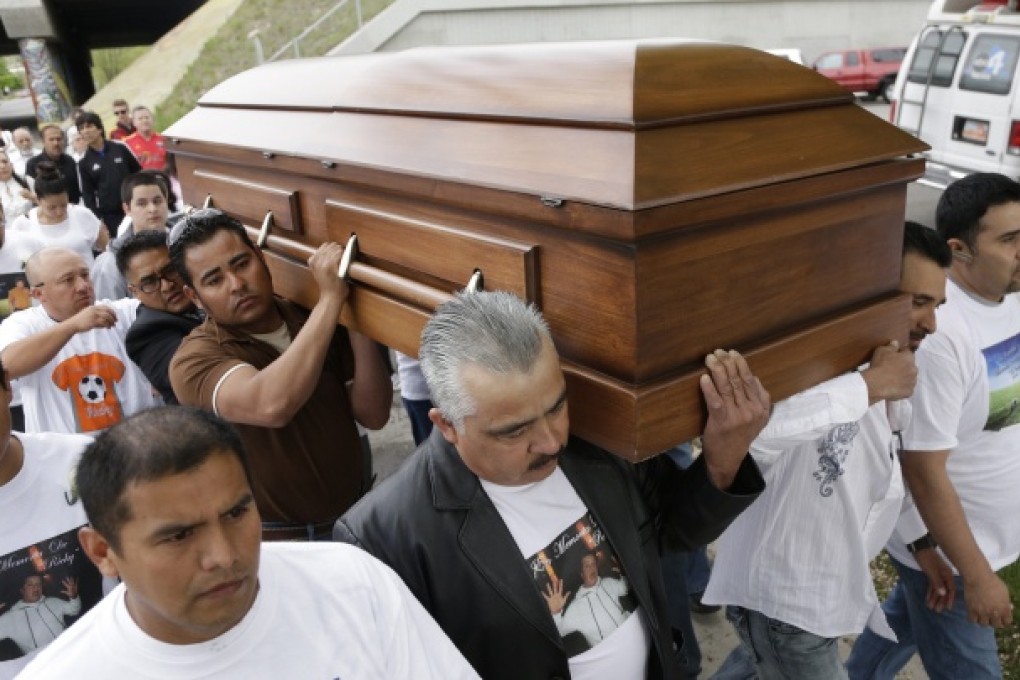 Mouners carry the casket of Ricardo Portillo along a street. Photo: AP