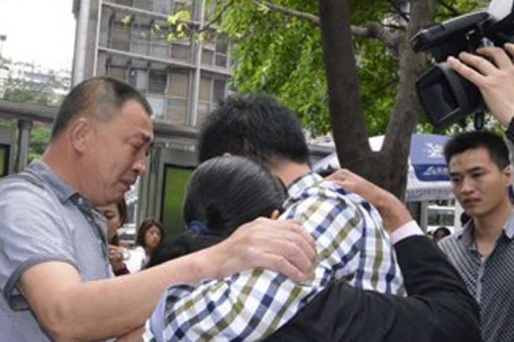 Luo Gang, right, reunites with his family. Photo: SCMP Pictures