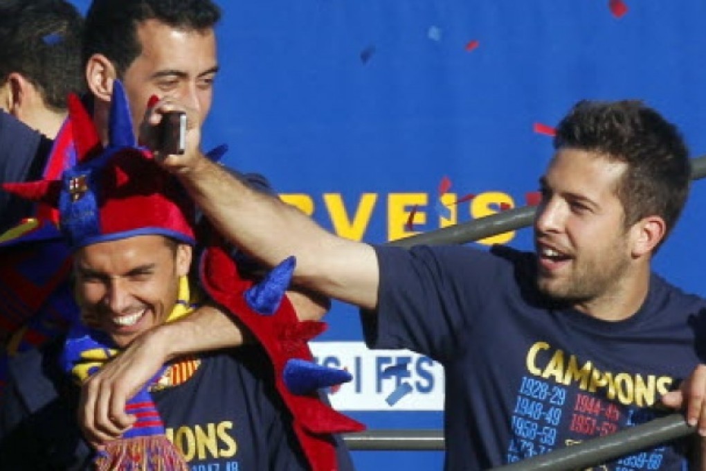 Barcelona's players Pedro Rodriguez, Sergio Busquets (top) and Jordi Alba (right). Rodriguez has claimed he and his teammates are targeting Real Madrid’s league record of 100 points after sealing the title last weekend. Photo: Reuters