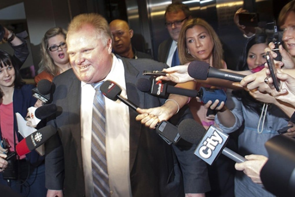 Toronto Mayor Ford is swarmed by reporters as he enters his offices at Toronto City Hall. Photo: Reuters