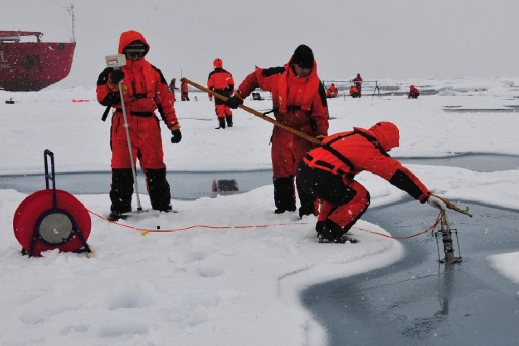 Chinese researchers test salt levels in Arctic ice. Photo: Xinhua