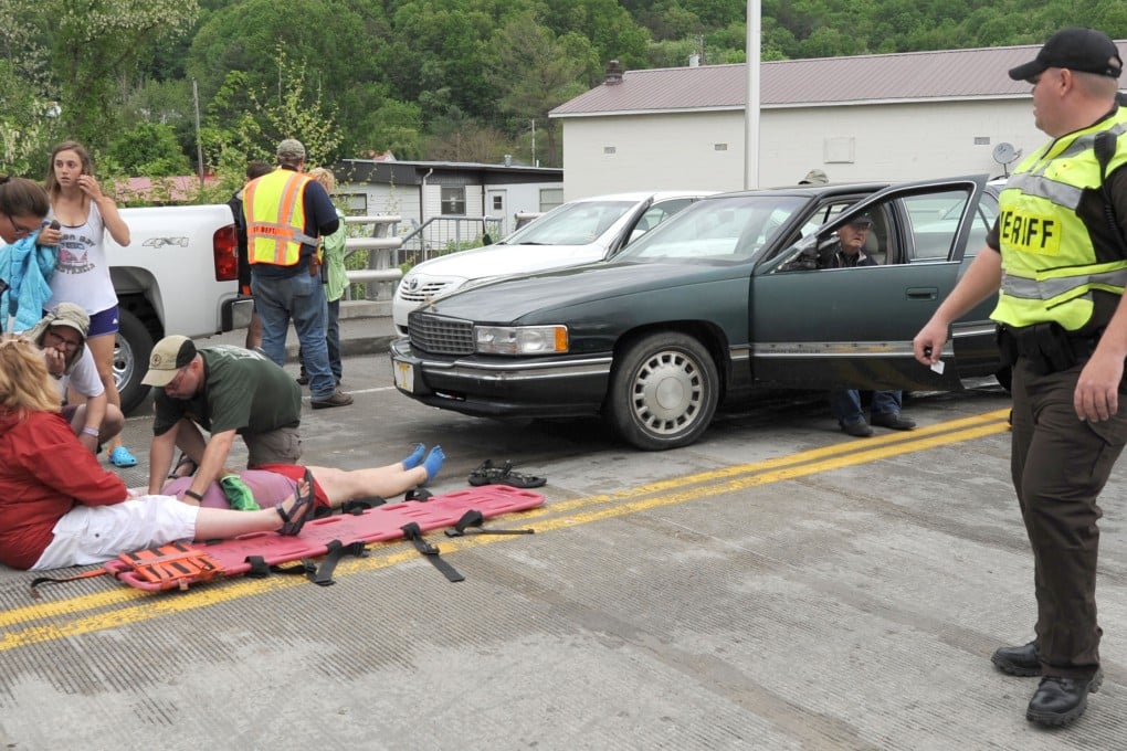 Emergency personnel respond to one of the people hit by a car during the beginning of the Hikers Parade at the Trail Days festival in Damascus, Virginia, USA. Photo: AP