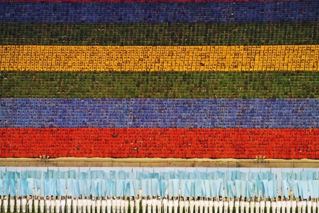 Performers use flip charts to create images for the Arirang. Photo: Jeremy Hunter