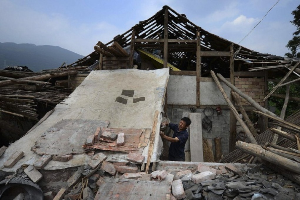 A man repairs a damaged house in Lushan, Sichuan. Habitat for Humanity wants to help restore quake-damaged homes. Photo: Reuters