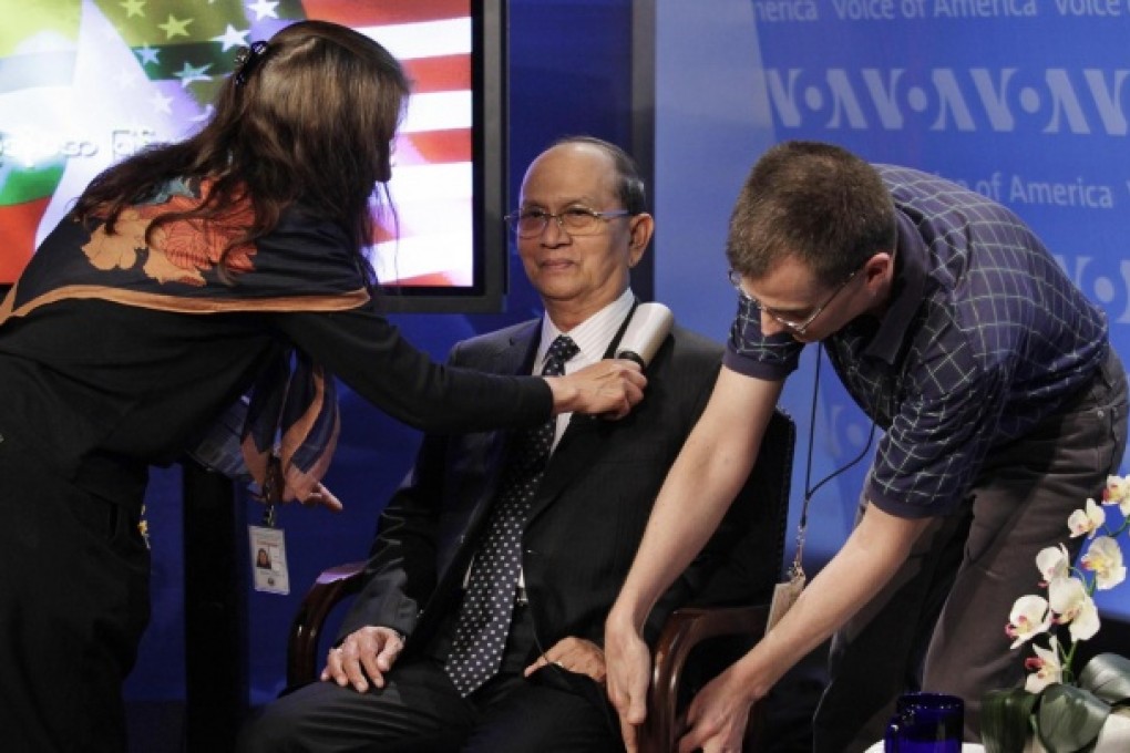 Staff help prepare President Thein Sein, of Myanmar, for a town hall event at the Voice of America in Washington. Photo: Reuters