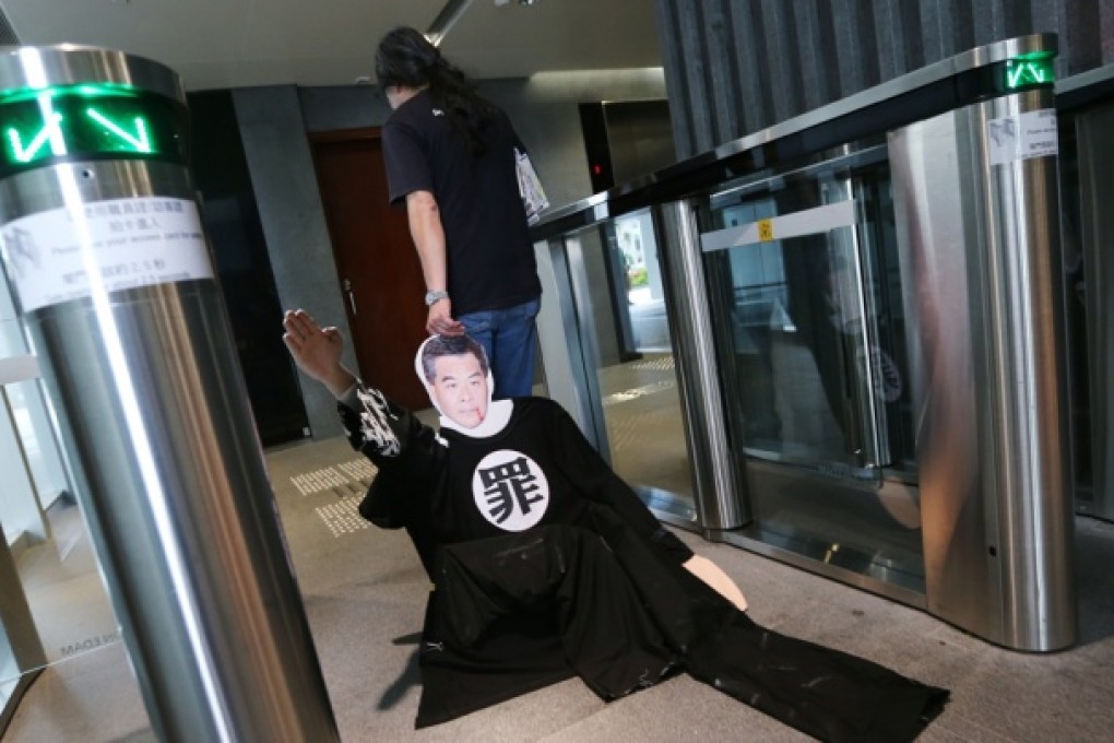 Leung Kwok-hung drags a mannequin of Leung Chun-ying into Legco after his protest. Photo: Sam Tsang