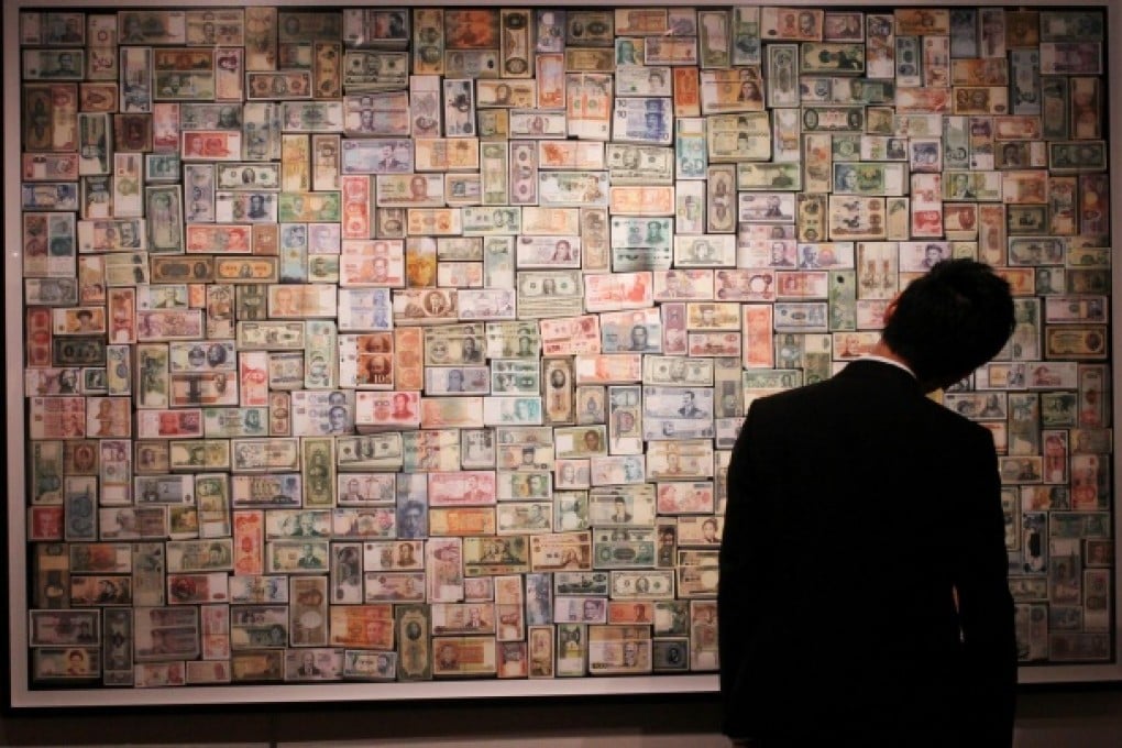 An visitor at Sotheby's Hong Kong Gallery in Admiralty inspects 556,066,792,000, a work by Hong Hao, on display in the Boundless: Contemporary Art exhibition. Photo: Felix Wong