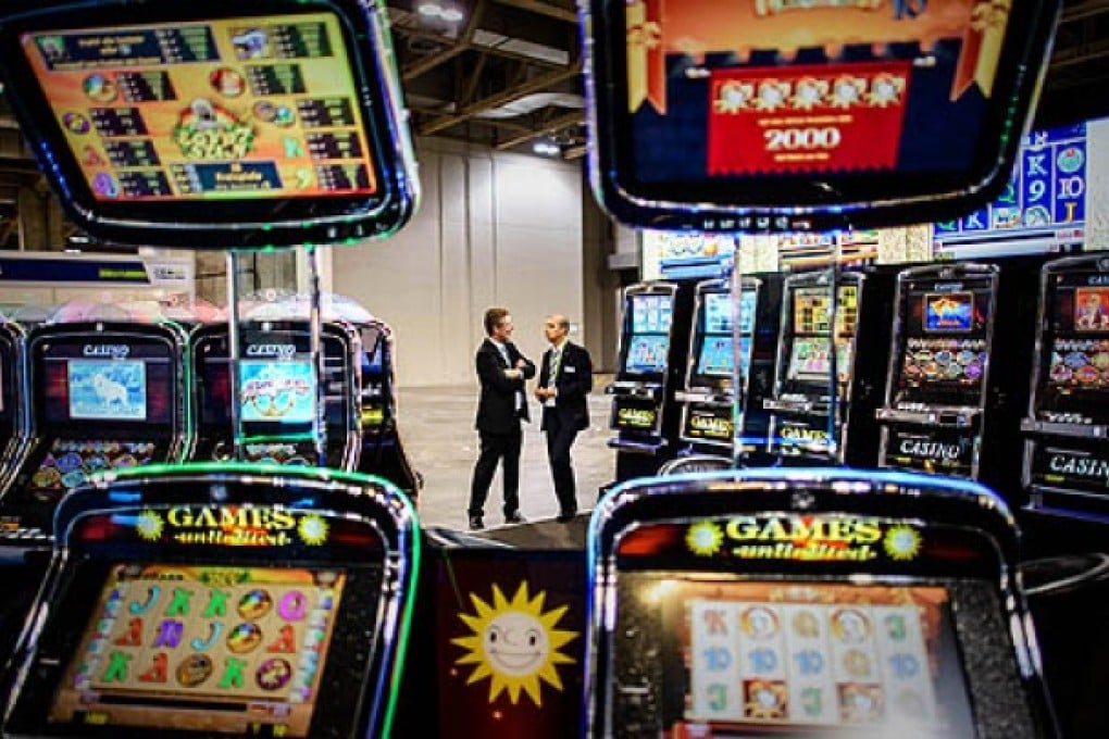 Exhibitors talk at the Global Gaming Expo Asia, a three-day fair of gambling innovations at the glitzy Venetian hotel in Macau, on Tuesday. Photo: AFP
