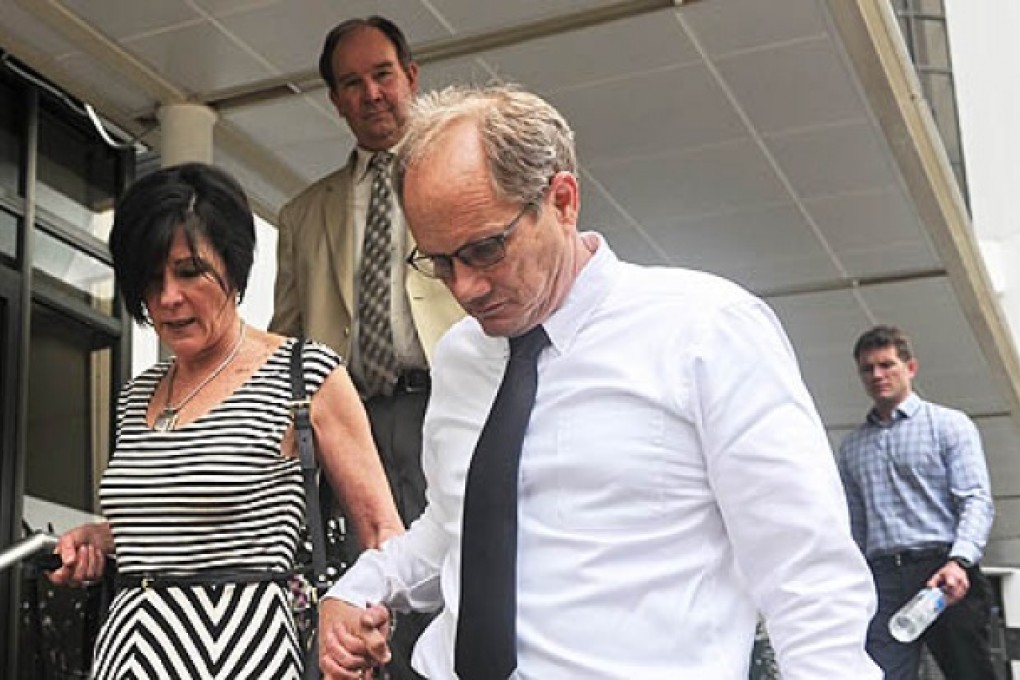 Rick Todd (right) and his wife Mary walk out during lunch break from the Subordinate courts in Singapore on Tuesday. Photo: AFP