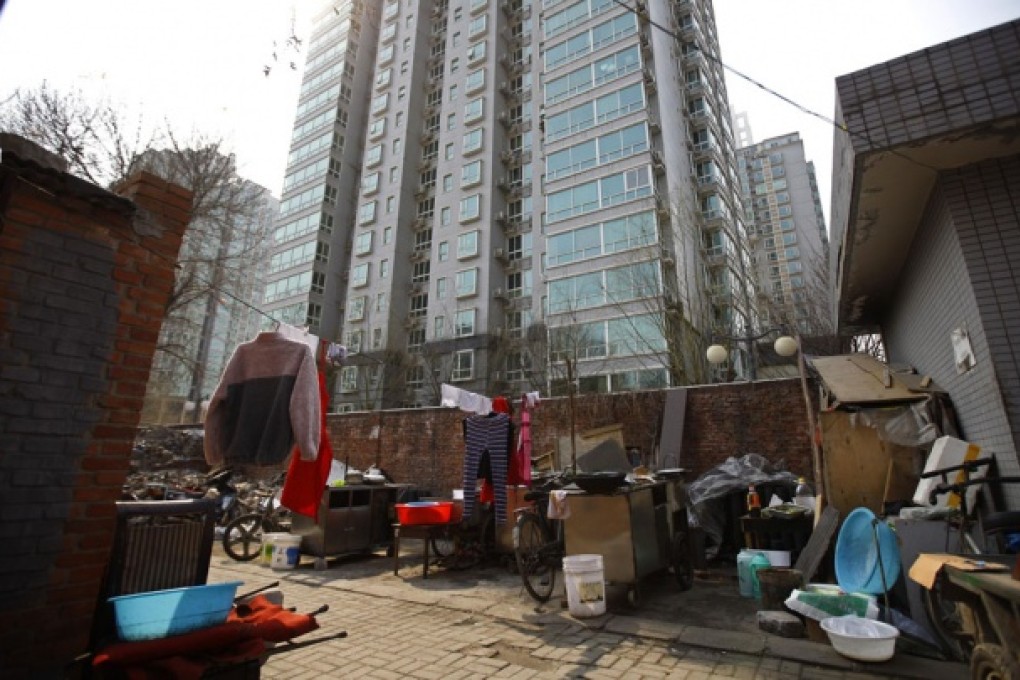A yard outside migrant workers' makeshift houses is seen next to a city residential compound in central Beijing. Photo: Reuters