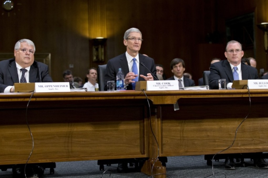 A taxing issue. Apple chief executive Tim Cook (centre), flanked by Apple chief financial officer Peter Oppenheimer (left), and Phillip Bullock, Apple's head of Tax Operations, testifies on Capitol Hill in Washington, Tuesday. Photo: AP