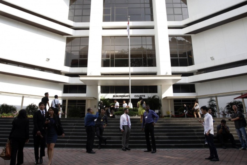 Eric Watnik (cente), spokesman for the US embassy in Singapore, waits for the Todd family, which did not show up, at the coroner's inquiry on Wednesday. Photo: Reuters