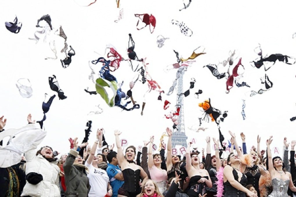 Women throw bras in the air to raise awareness of the fight against breast cancer. Photo: AFP
