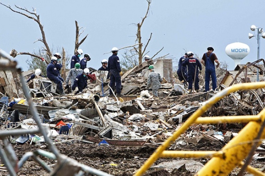 Rescue workers look through the rubble at Plaza Towers Elementary school in Moore. Photo: Reuters