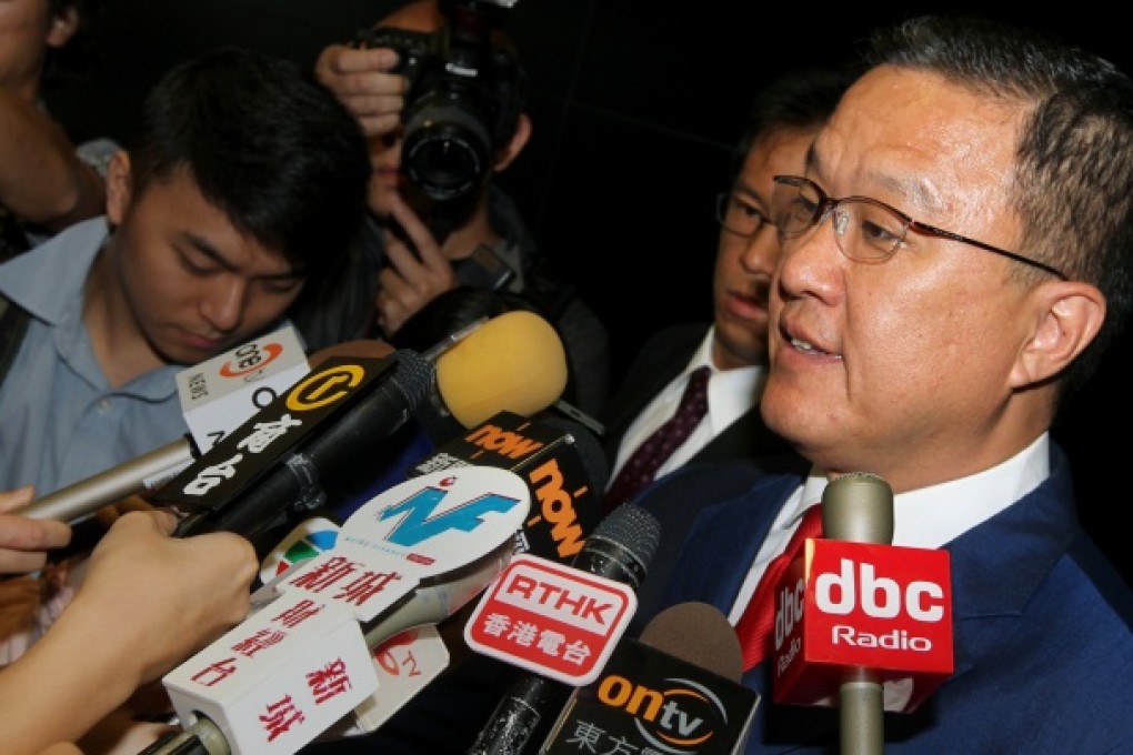 Executive Councillor Barry Cheung Chun-yuen speaks to media after police seized evidences from the office of Hong Kong Mercantile Exchange's (HKMEx) office at Cyberport. Photo: May Tse