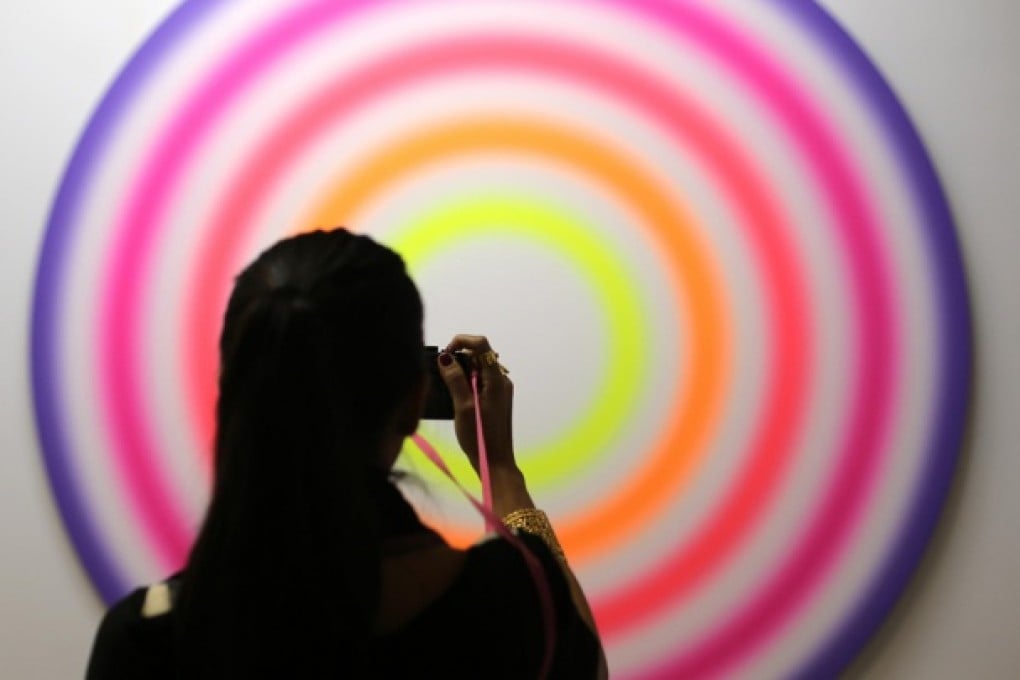 A woman admires an artwork titled FUNFZENHNTERMARZZWEITAUSENDUNDDREIZEHN by Ugo Rondinone during a show preview at the Convention Centre. Photo: Sam Tsang