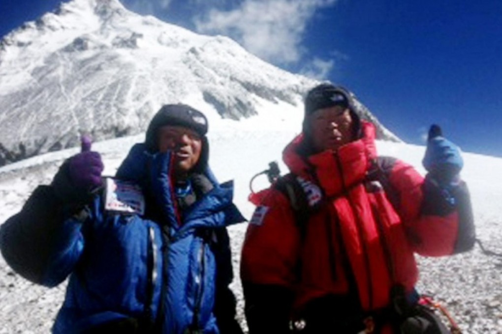 Adventurer Yuichiro Miura (right) and his son Gota pose for a photo as they leave camp to begin the last stage of their ascent. Photo: AFP
