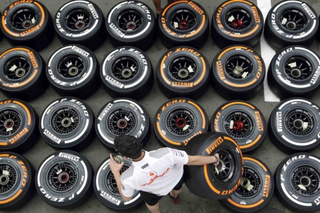 McLaren mechanic arranges Pirellis tyres in the paddock ahead of the Spanish F1 Grand Prix in Montmelo. Photo: Reuters