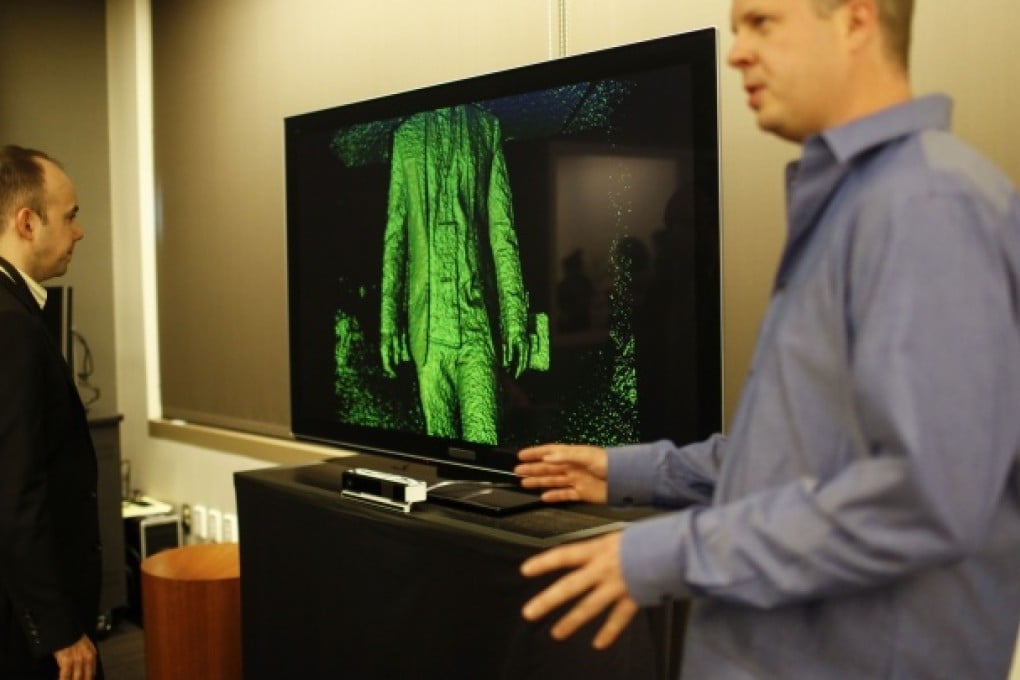 Kinect group program manager Scott Evans (right) demonstrates the latest Kinect sensor for the Xbox One this week. Photo: Reuters