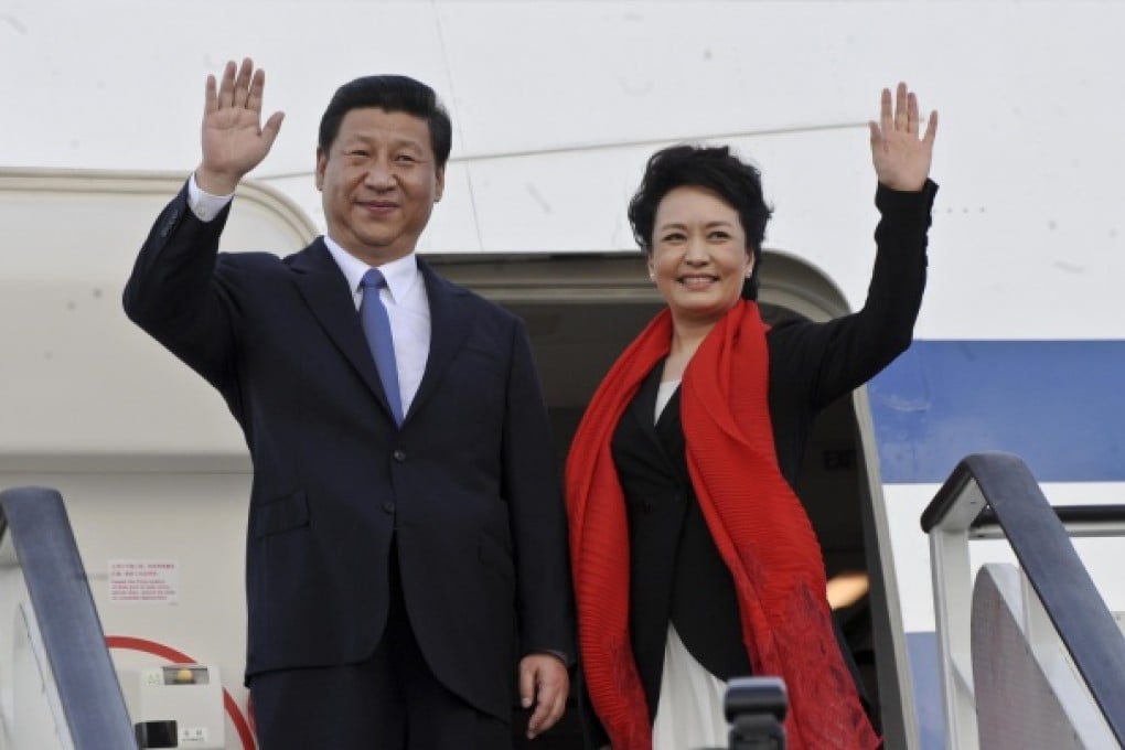 Xi Jinping and his wife, Peng Liyuan, wave before boarding a plane in Tanzania. It was on this trip to Africa that Peng emerged as a first lady with genuine star power. Photo: AP