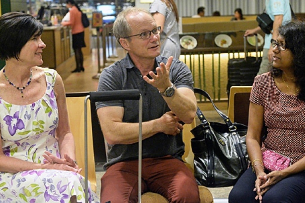 Rick Todd (centre) and his wife Mary (left) chat with their family lawyer Gloria James-Civetta at the departure hall of Changi International Airport in Singapore on Thursday. Photo: AFP