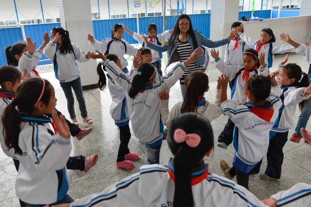 A teacher in Shangli town, Lushan county, leads a class in a makeshift classroom that was set up in the aftermath of a magnitude seven earthquake that rocked Sichuan province last month. Photo: Xinhua