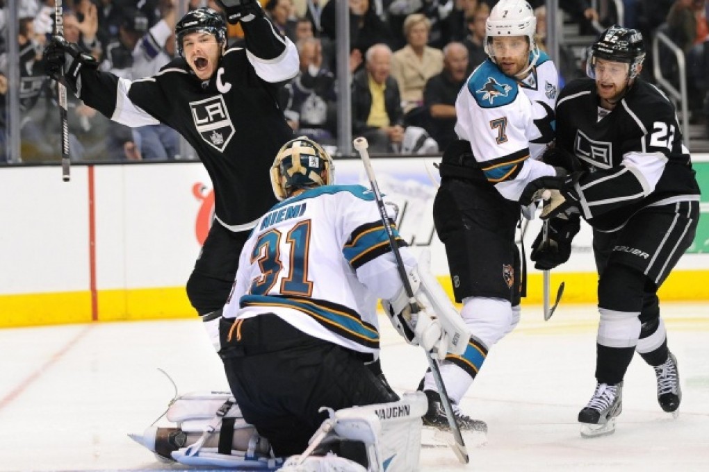 The Kings' Dustin Brown celebrates a goal scored by teammate Slava Voynov. Photo: MCT