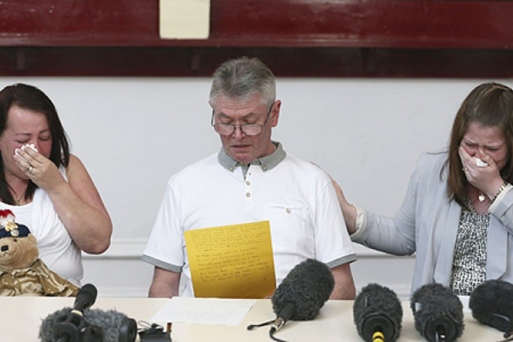 Murdered British soldier Lee Rigby's stepfather Ian, seated between his mother Lyn (left) and his wife Rebecca Rigby, reads a statement during a press conference at the Regimental HQ of his unit, the Royal Regiment of Fusiliers at Bury in Greater Manchester, England, on Friday. Photo: AP