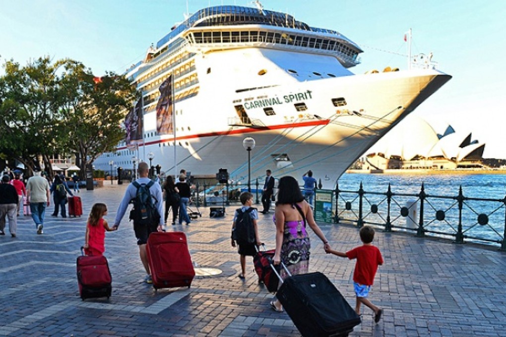 Passengers arrive at Sydney's Circular Quay to board the cruise ship Carnival Spirit for a Pacific cruise. Photo: AFP