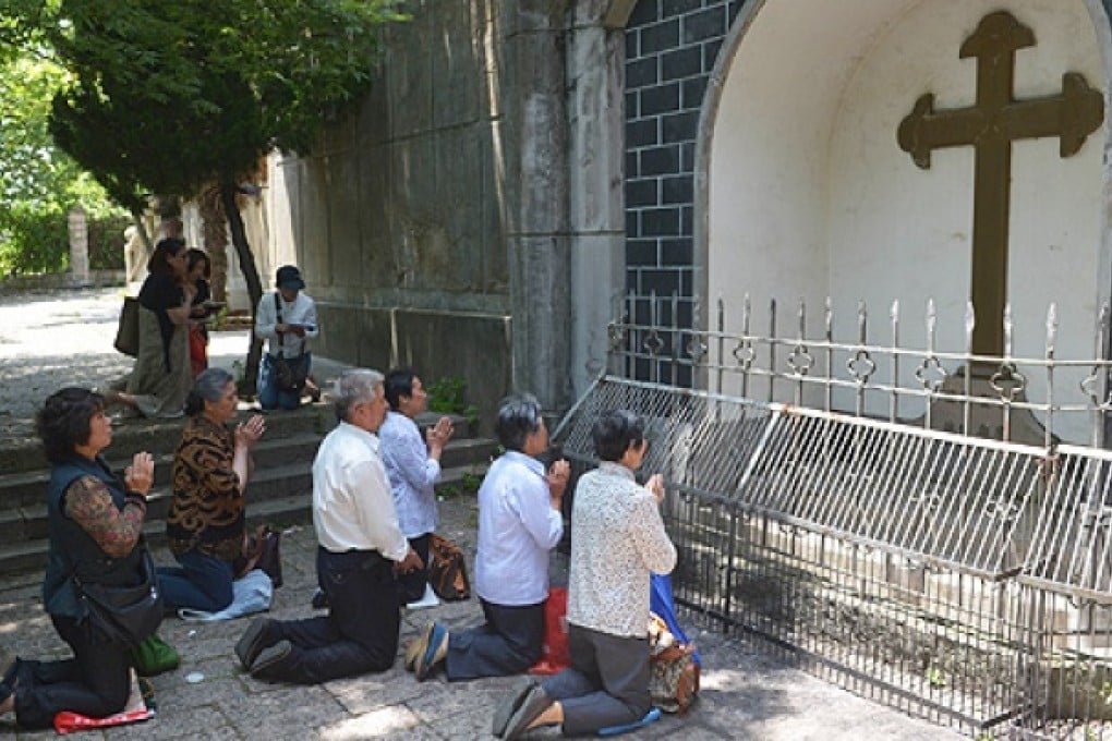 Catholics pray at Our Lady of Sheshan Basilica Catholic church in Shanghai on Friday. Photo: AFP