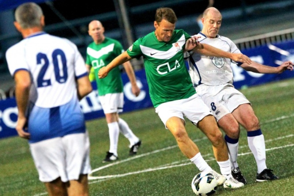 Teddy Sheringham of CLA Discovery Bay is challenged by Graham Lane of HKFC Chairman's Select during the Sevens last night at Football Club. CLA won 1-0. Photo: Edward Wong