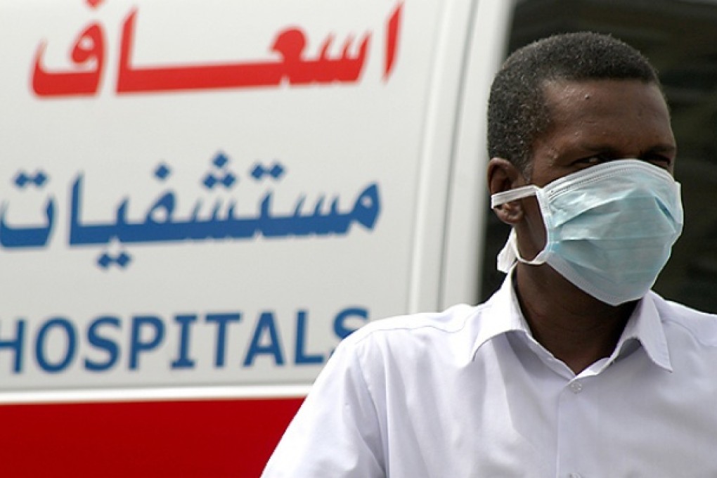 A man, wearing a surgical mask as a precautionary measure against the novel coronavirus, walks near a hospital in Khobar city in Dammam. Photo: Reuters