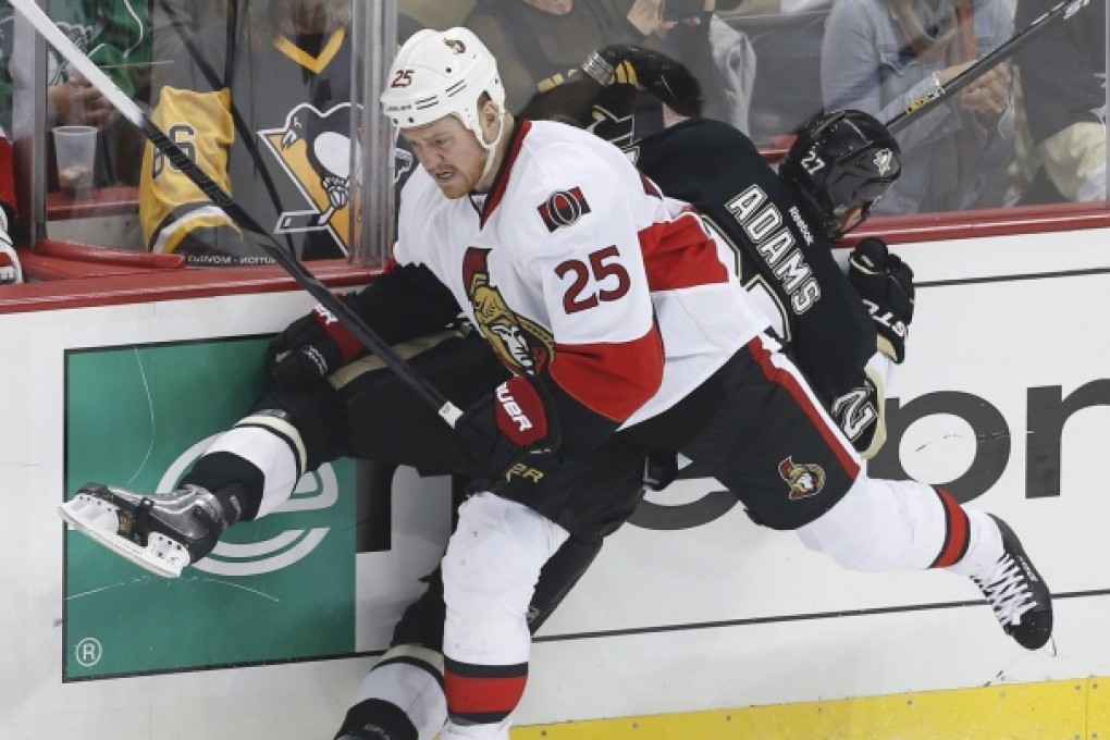 Ottawa Senators' Chris Neil (left) checks Pittsburgh Penguins' Craig Adams during game five of their semi-final series. Photo: Reuters