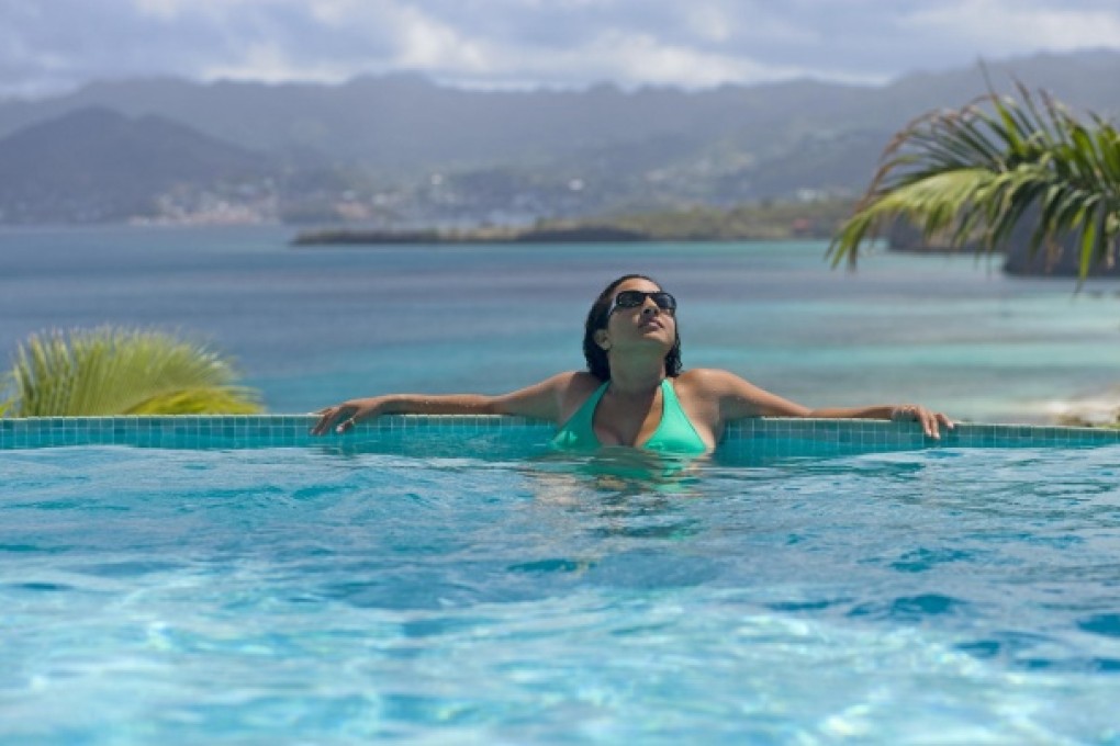 Guests can relax in a pool overlooking the beach.