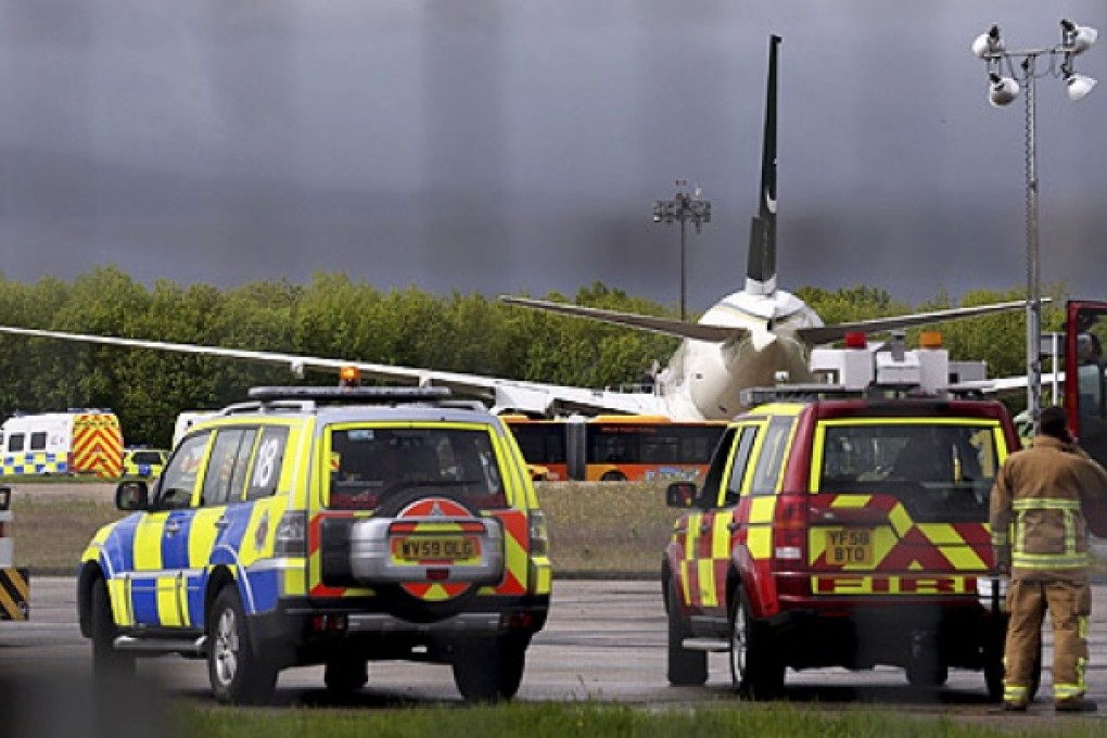 Police and rescue service vehicles wait at Stansted Airport, England, on Friday, after Pakistan International Airlines flight PK709 bound for Manchester from Lahore, was diverted to Stansted following an incident on board. Photo: AP
