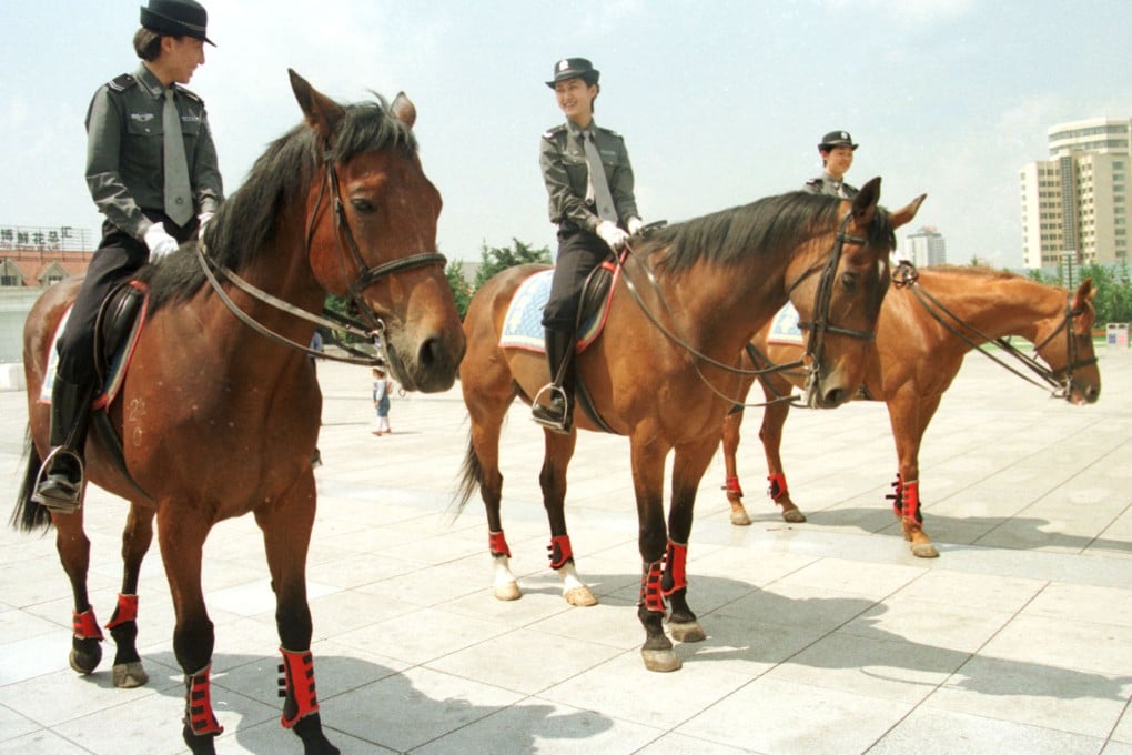 Policewomen patrol on horseback at a park in Dalian, Liaoning province in northeast China. Photo: AP