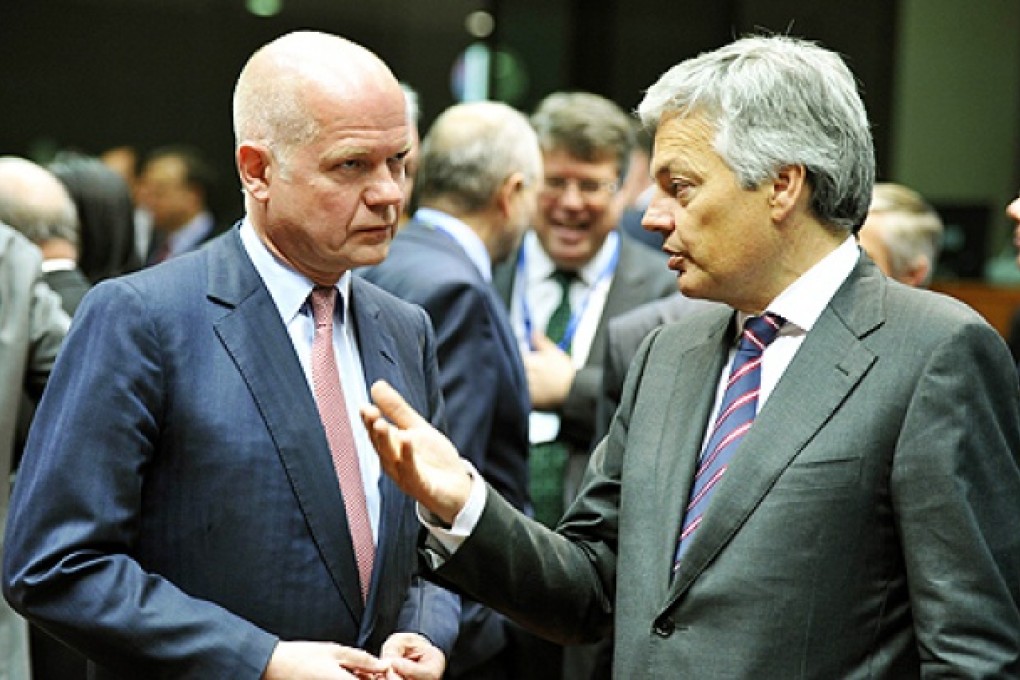 British Foreign Secretary William Hague (left) and Belgium's Foreign minister Didier Reynders talk prior to the Foreign Affairs Council on Monday at the EU Headquarters in Brussels. Photo: AFP