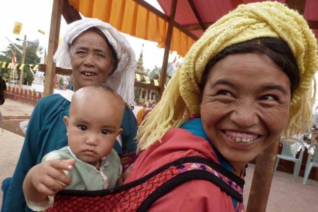 An ethnic Wa woman carries a baby during a religious ceremony. Photo: AFP