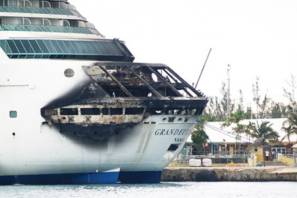 The fire-damaged exterior of Royal Caribbean's Grandeur of the Seas cruise ship is seen while docked in Freeport, Grand Bahama island, on Monday. Photo: AP
