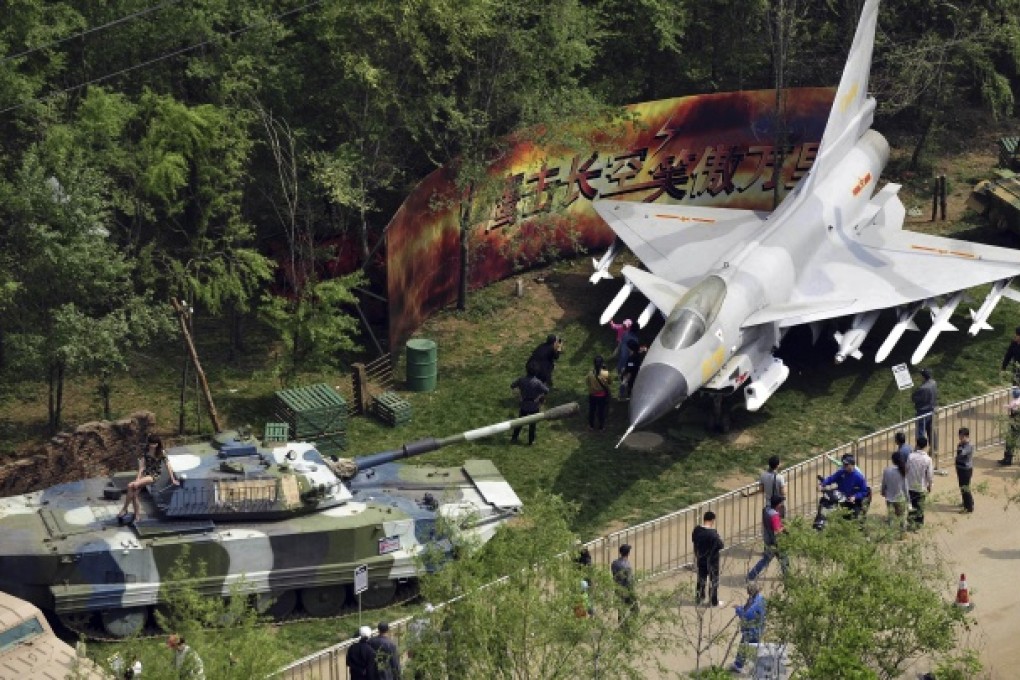 A Chinese-made J-10 fighter jet and tank are on display in a residential estate in Shenyang, Liaoning. The real estate developer is a subsidiary of the state-owned Poly Group. Photo: AP