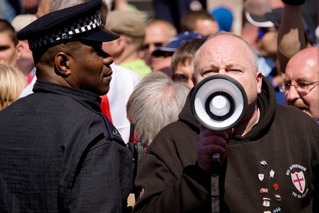 Supporters of the far-right English Defence League (EDL) shout slogans near Downing Street in central London. Photo: AFP