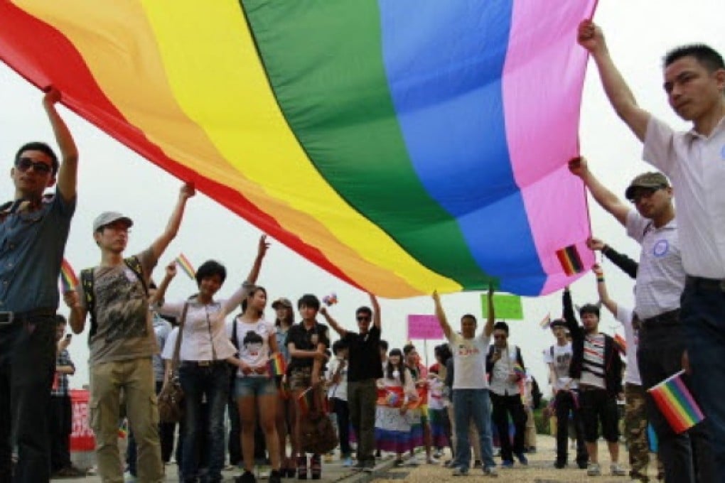 Activists hold a rainbow flag at a gay pride parade in Changsha in south China's Hunan province on May 17. Photo: EPA