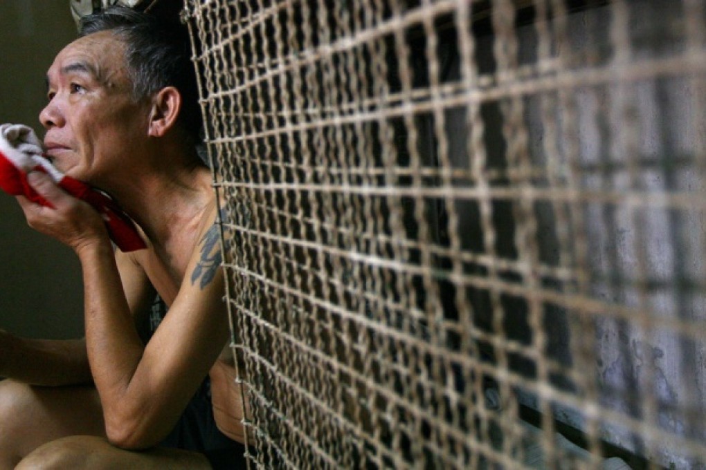 Kong Siu-kau (above) at his cage apartment in Sham Shui Po in 2009; swimmers take to the water for the crossharbour race in October 1975 (below right). Photos: Sam Tsang, P.Y. Tang