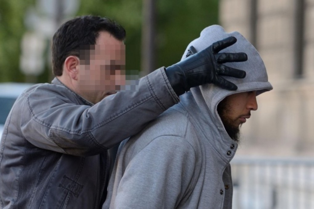 Police escort the suspect accused of stabbing a French soldier near Paris. Photo: AFP