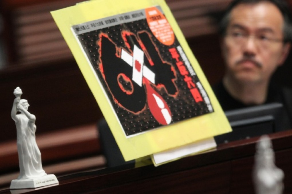 A Goddess of Democracy statue and a poster condemning the massacre sit alongside lawmaker Fernando Cheung Chiu-hung. Photo: K. Y. Cheng
