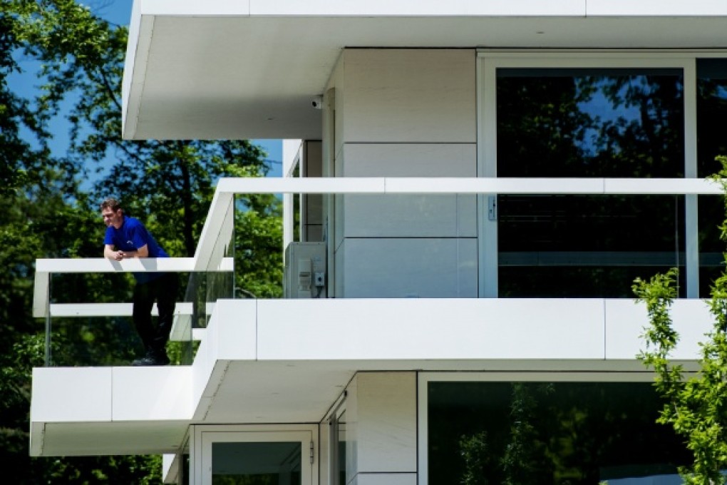Police raid a house in Hilversum as part of an investigation into convicted Dutch gangster Willem Holleeder. Photo: AFP