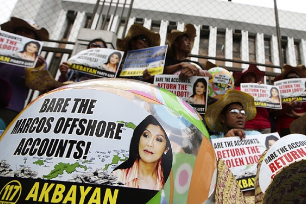Protesters target the offshore wealth of the Marcos family in Manila. Photo: AP
